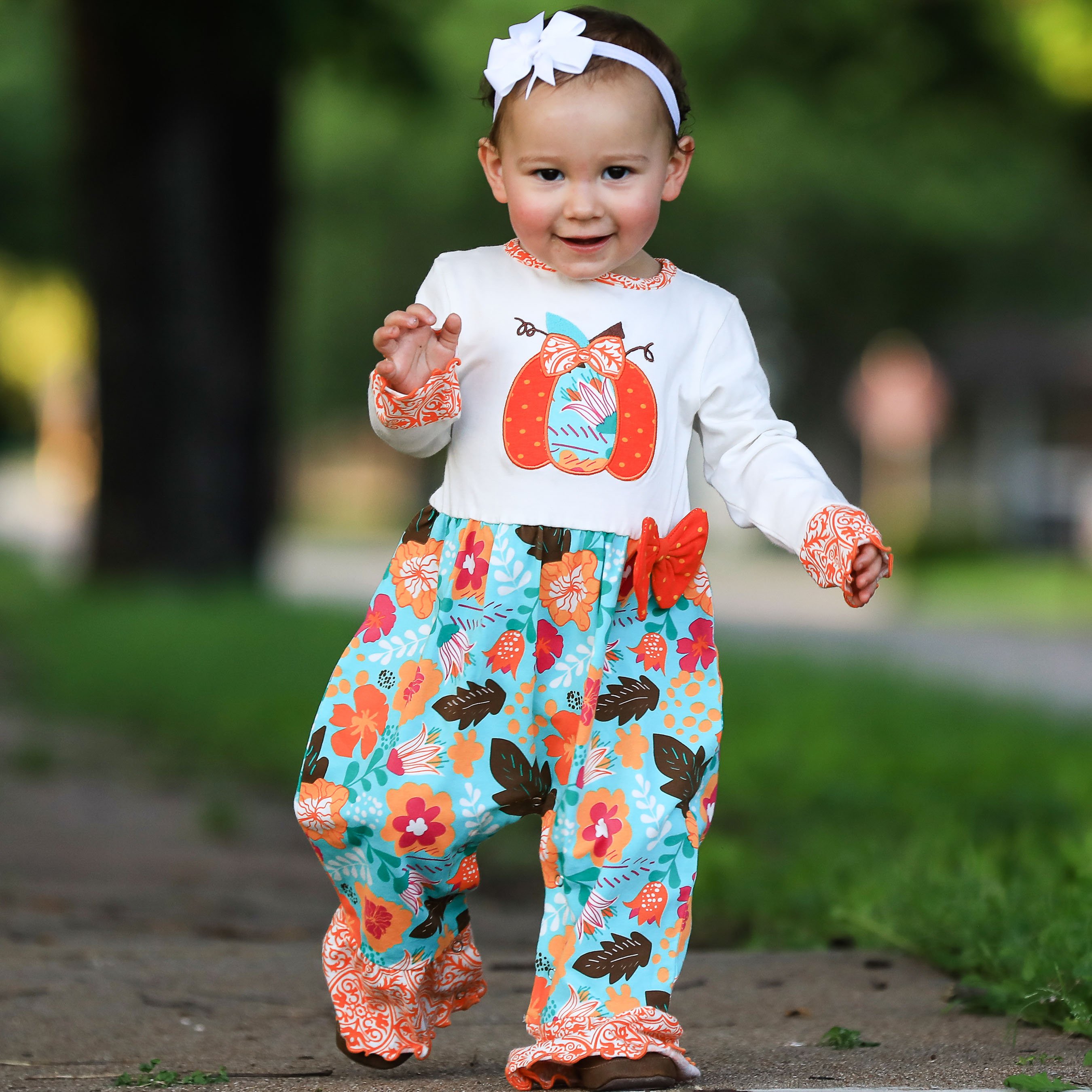 AnnLoren Baby Toddler Girls Pumpkin Romper in soft cream knit with floral prints and pumpkin embroidery.